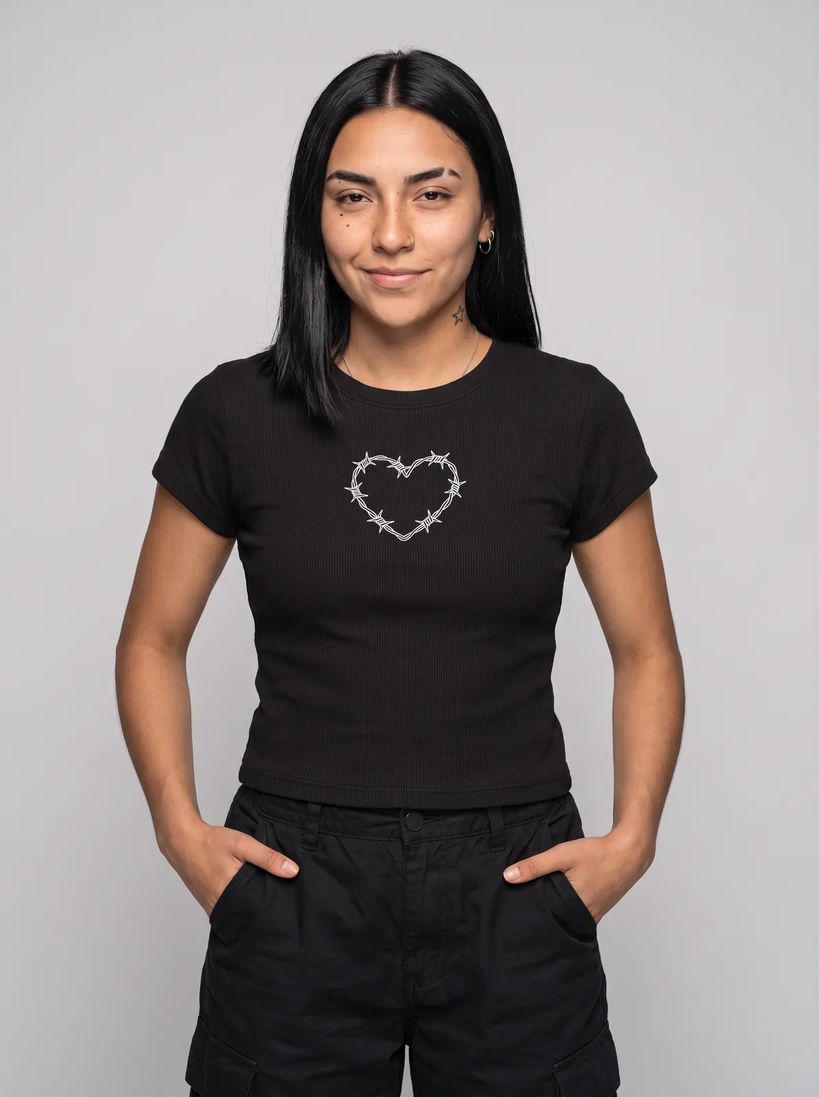 Nova Reyes wearing the BARBED Baby Tee in Black, waist up crop
