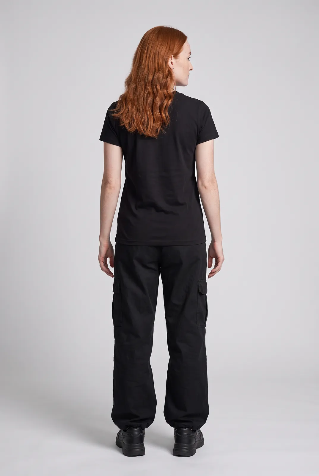 Maeve Gallagher wearing the BITE ME Tee in Black, back turn