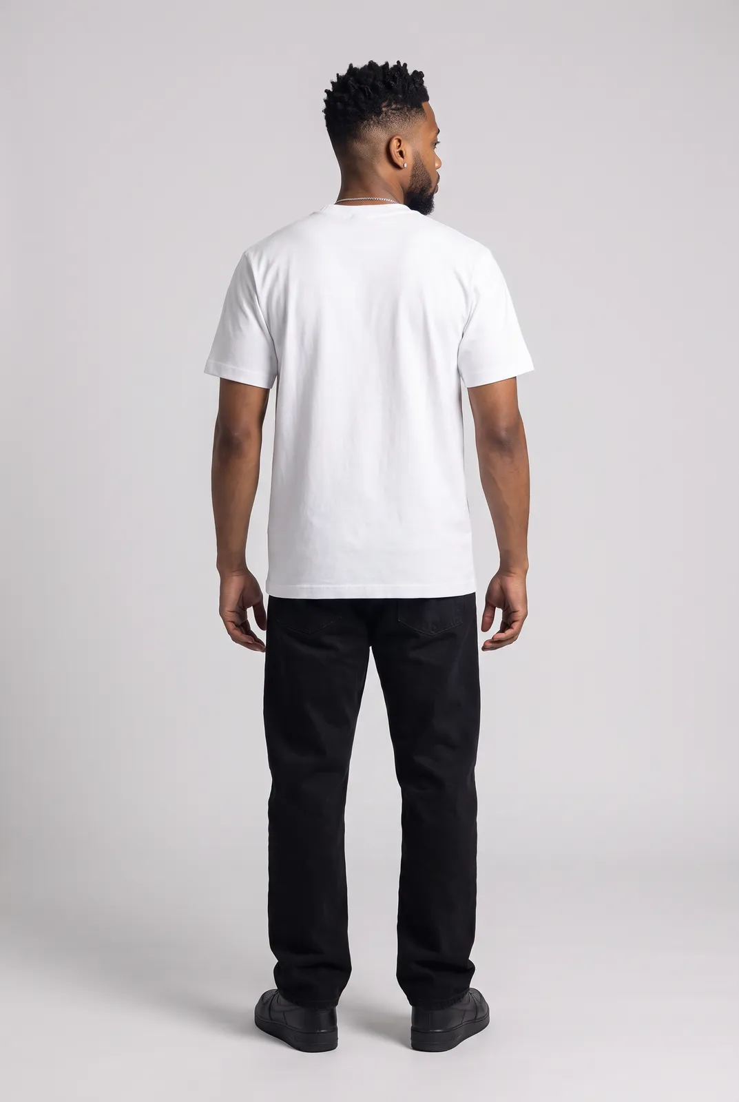 Malik Carter wearing the DIAL TONE Tee in White, back turn