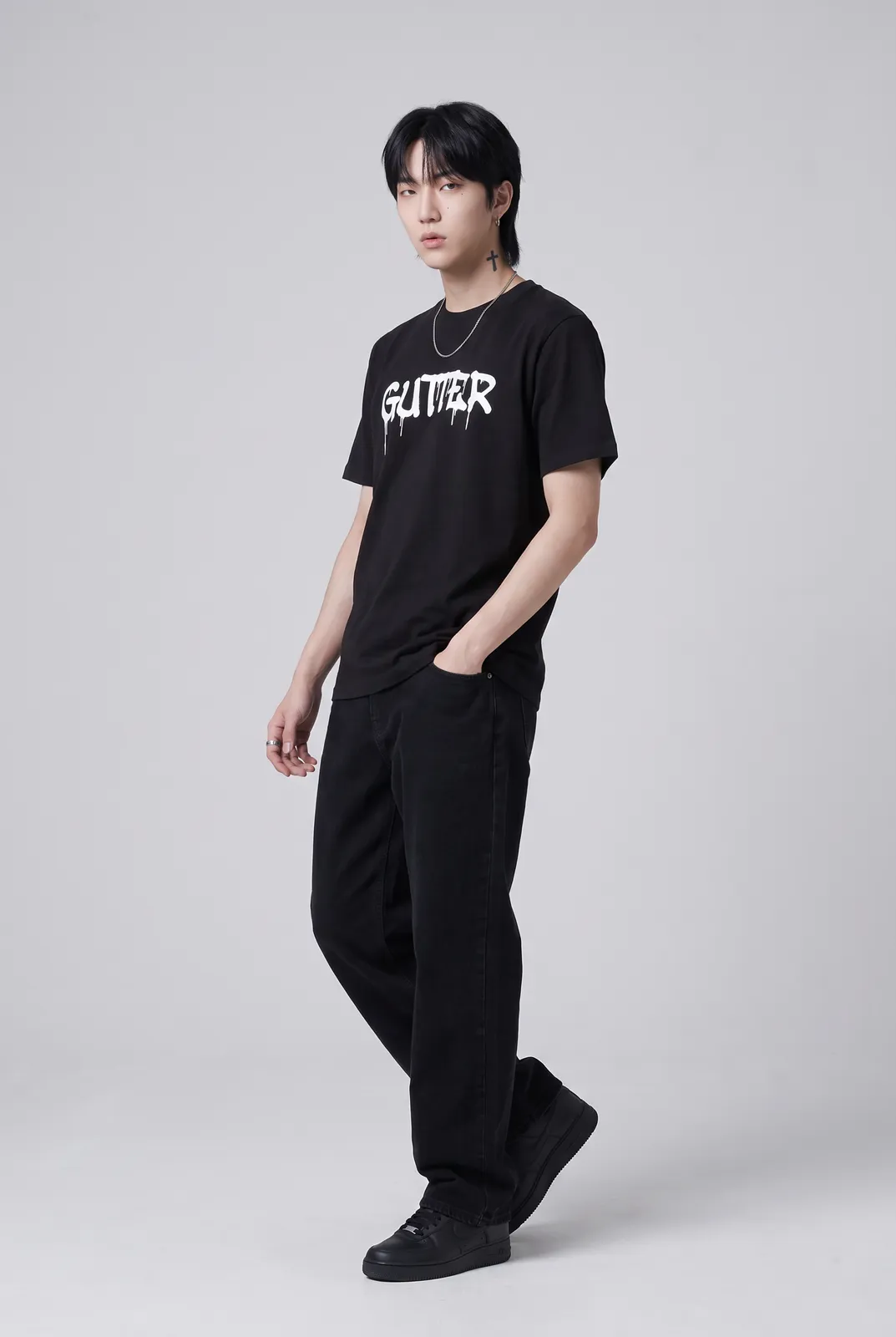 Jae Park wearing the GUTTER Tee in Black, three quarter lean