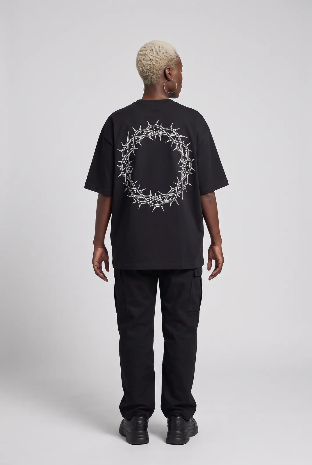 Imani Okafor wearing the HALO Oversized Tee in Black, back turn