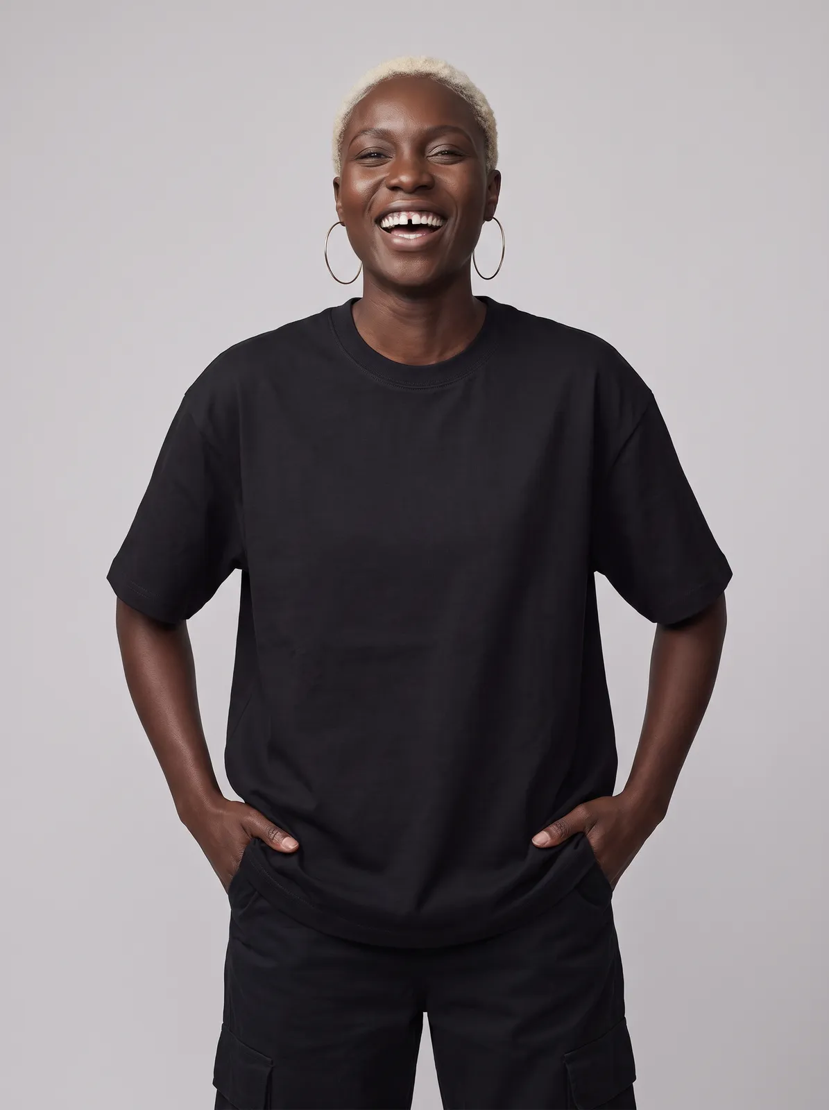 Imani Okafor wearing the HALO Oversized Tee in Black, waist up crop