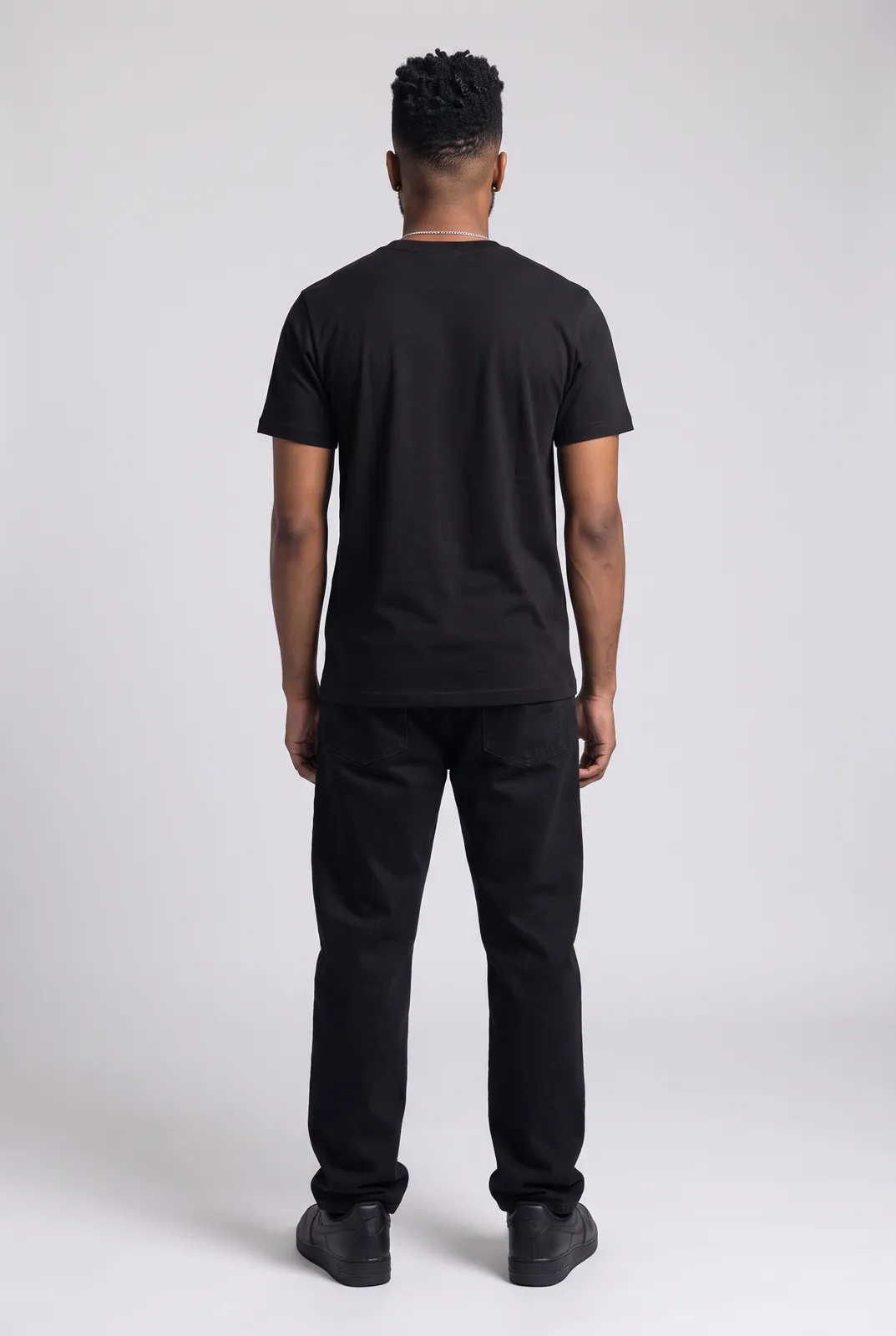 Malik Carter wearing the HEAVY ROTATION Tee in Black, back turn