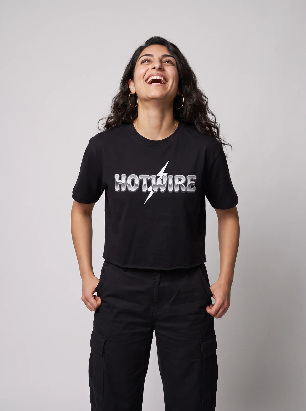 Amara Haddad wearing the HOTWIRE Cropped Tee in Black, waist up crop
