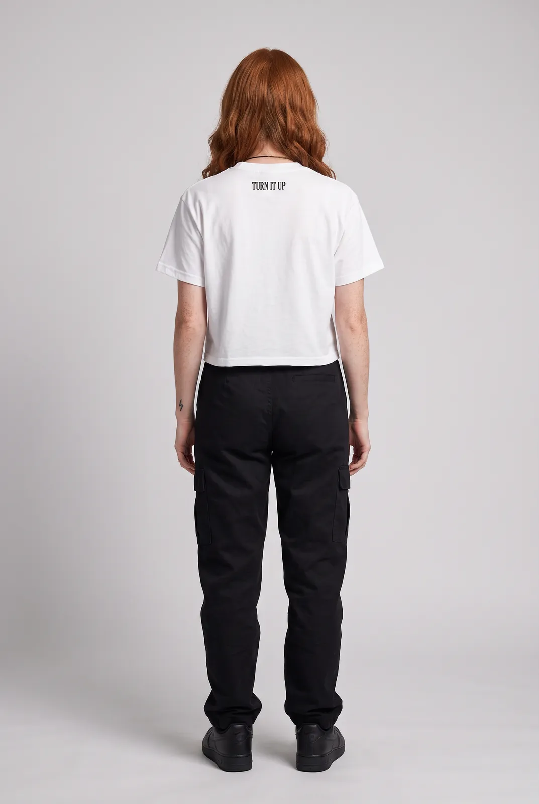 Maeve Gallagher wearing the LOUD Cropped Tee in White, back turn