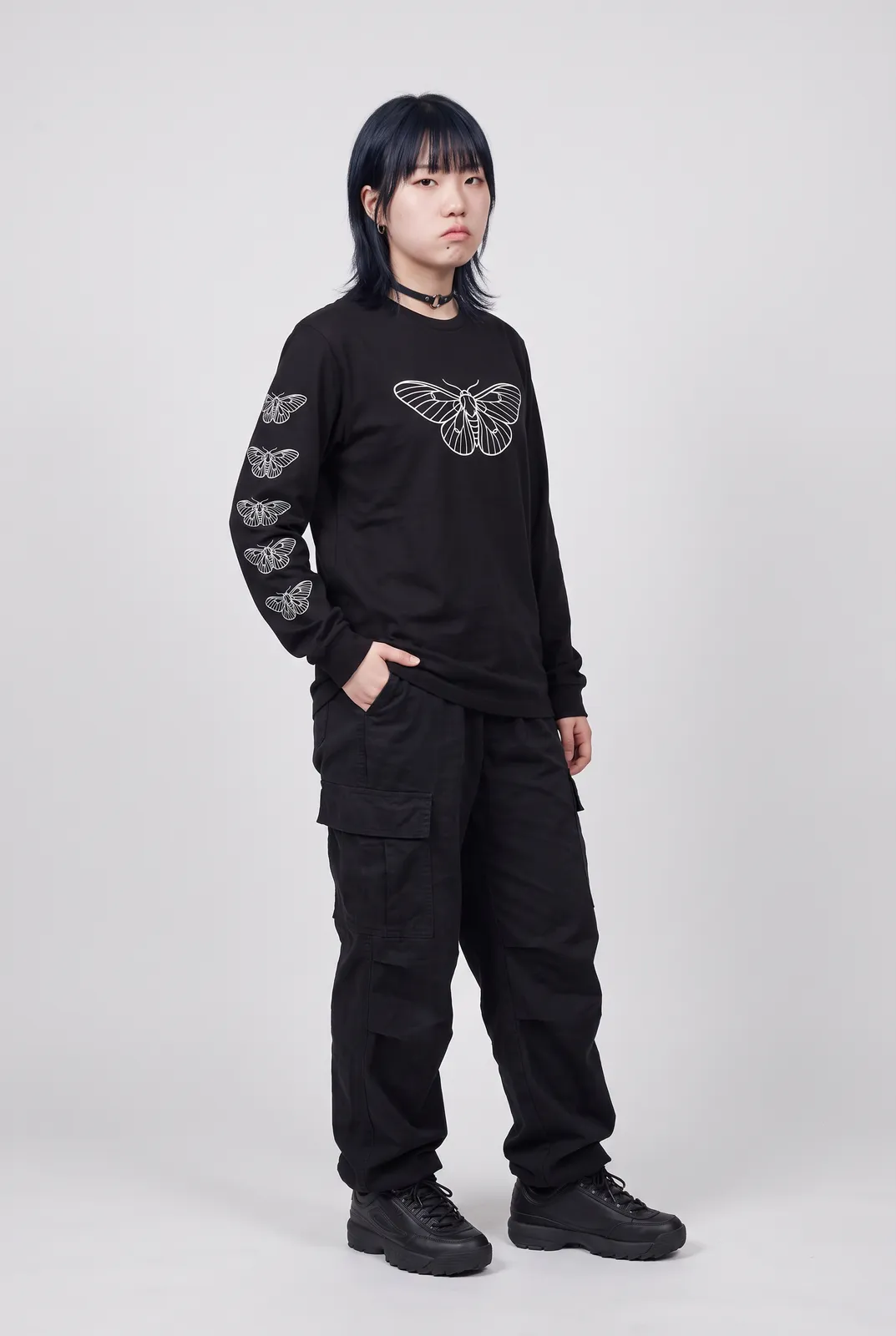 Sora Tanaka wearing the MOTH Longsleeve in Black, three quarter lean