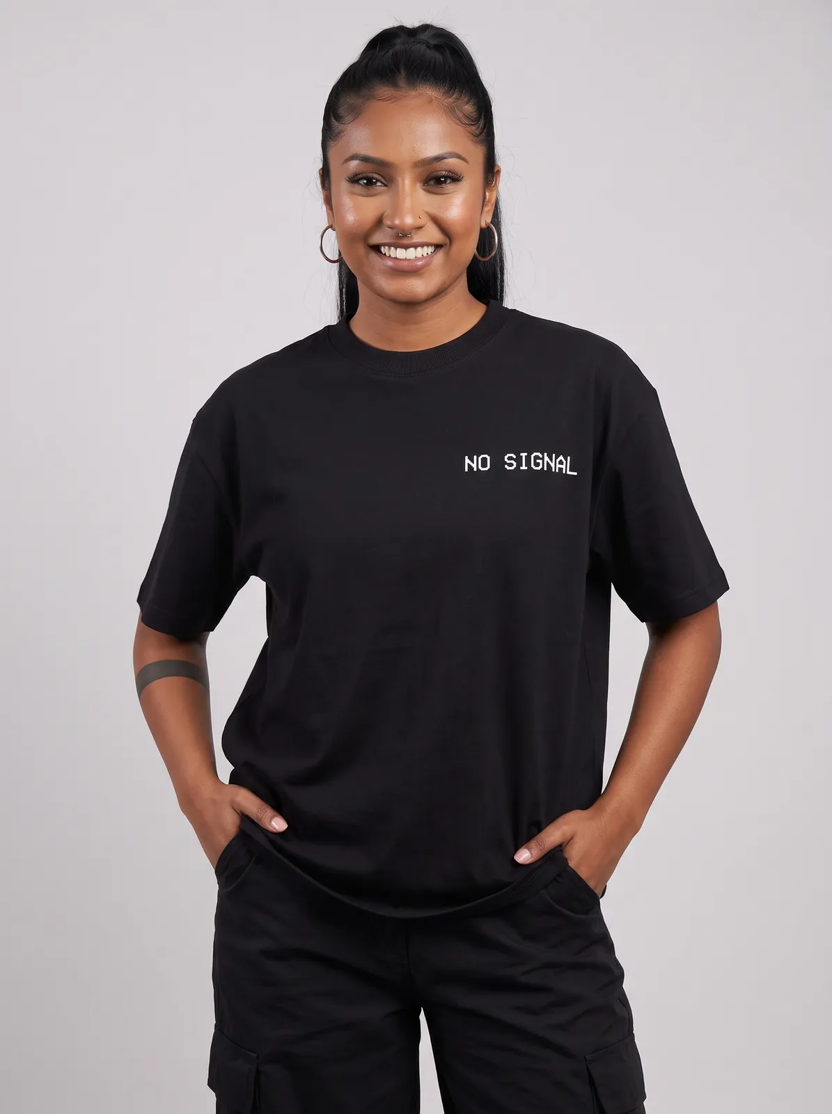 Zara Mehta wearing the NO SIGNAL Oversized in Black, waist up crop