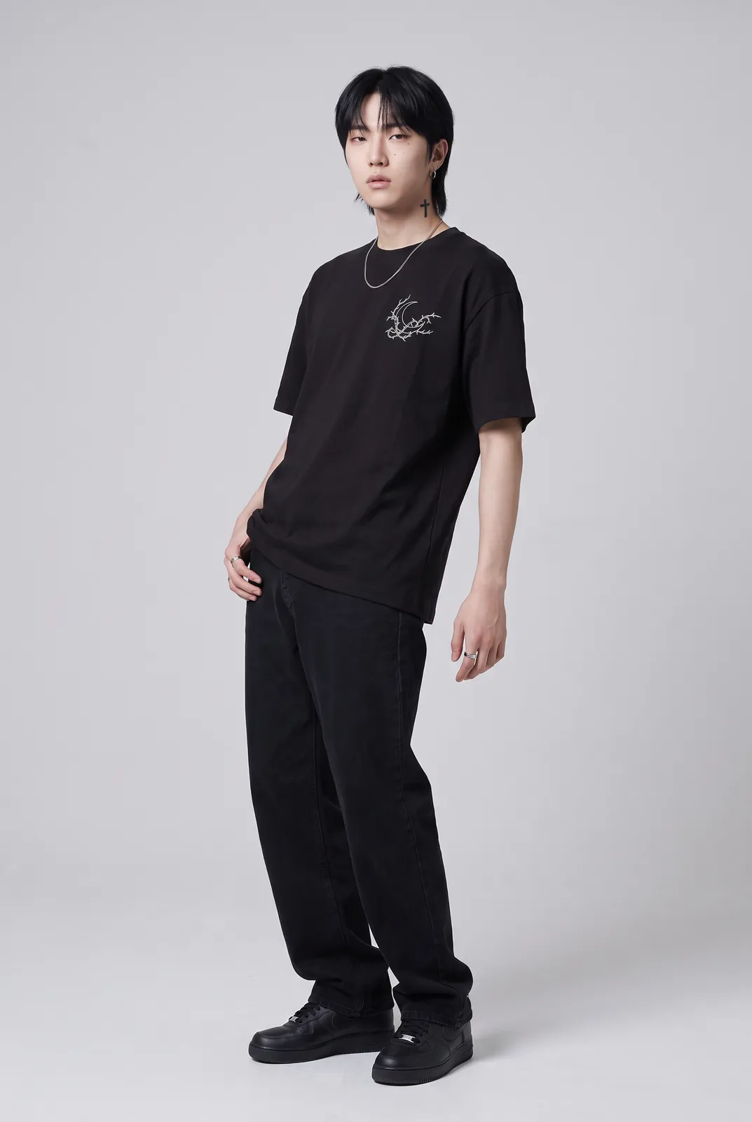 Jae Park wearing the NOCTURNE Oversized in Black, three quarter lean