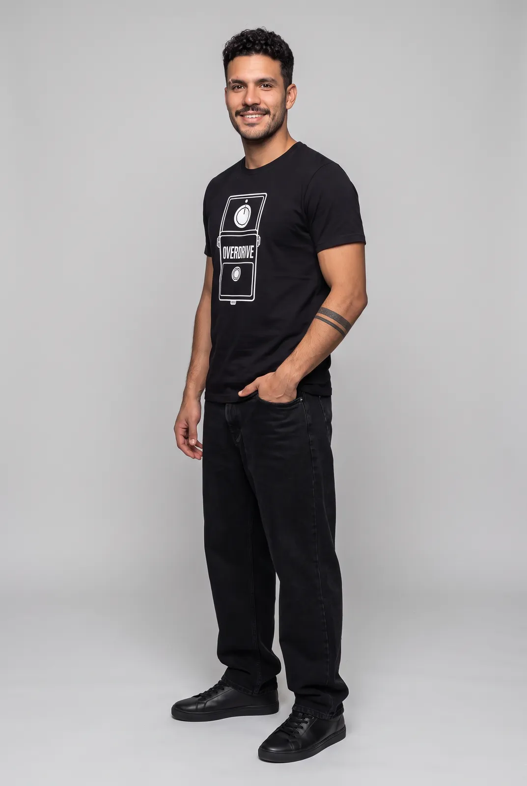 Diego Alvarez wearing the OVERDRIVE Tee in Black, three quarter lean