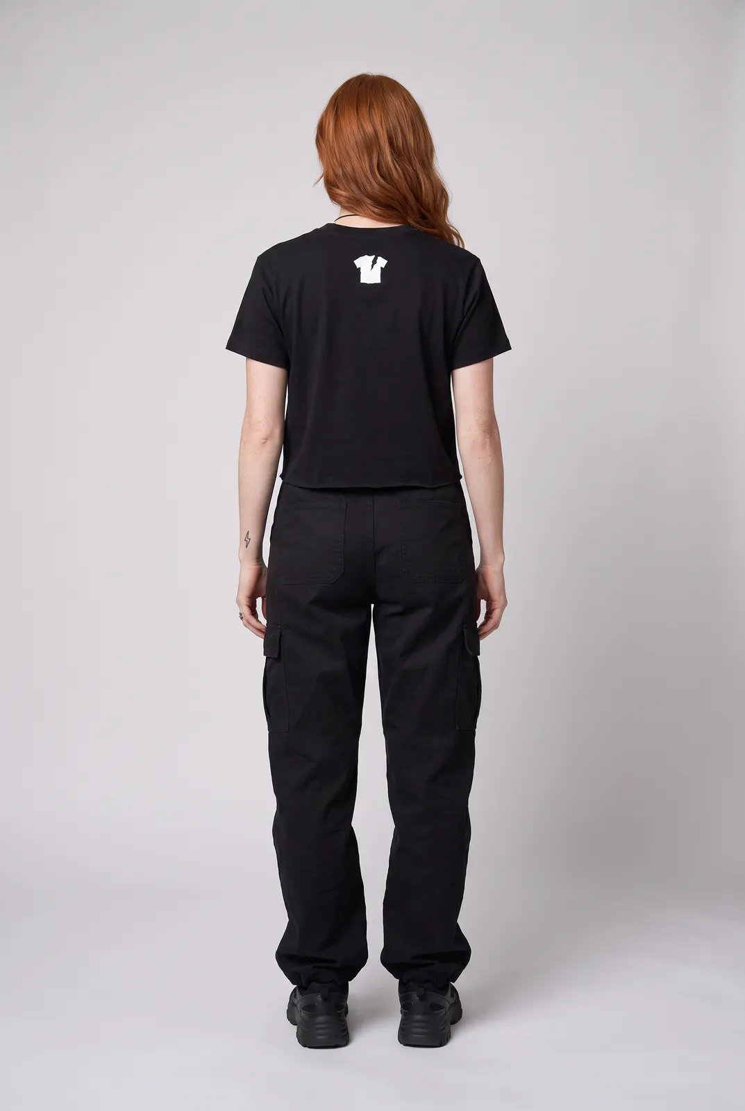 Maeve Gallagher wearing the RIOT Tee in Black, back turn