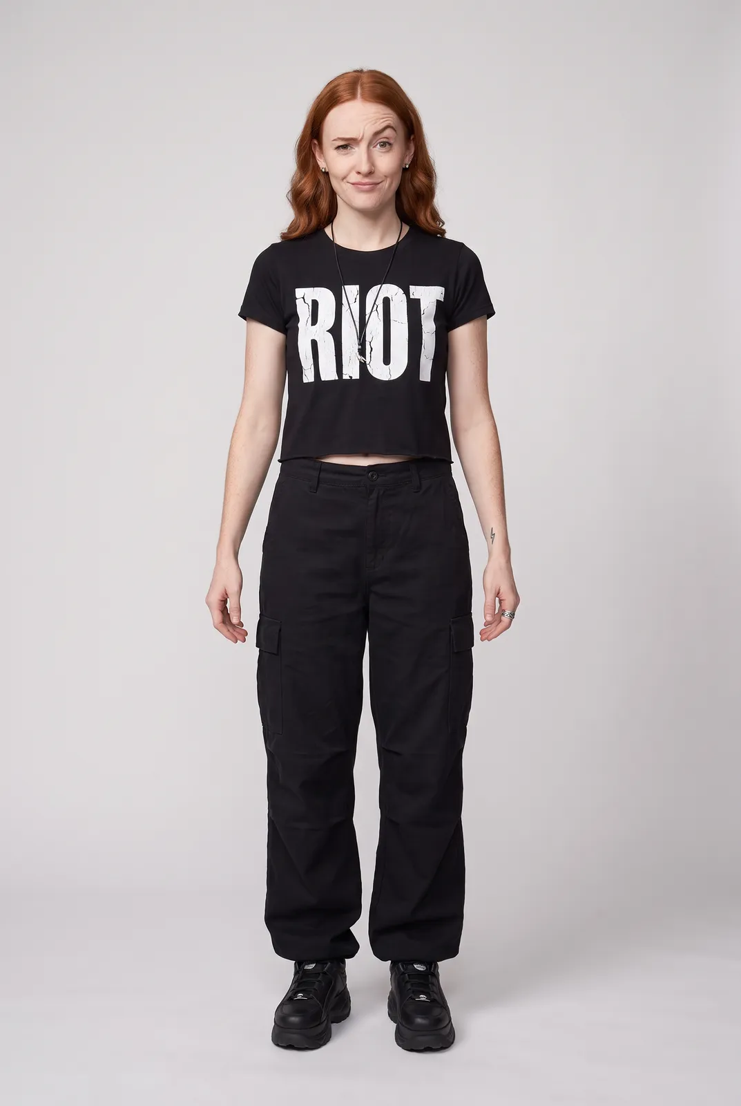 Maeve Gallagher wearing the RIOT Tee in Black, front hero