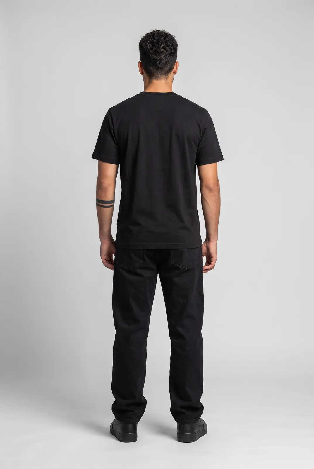 Diego Alvarez wearing the WASTELAND Tee in Black, back turn