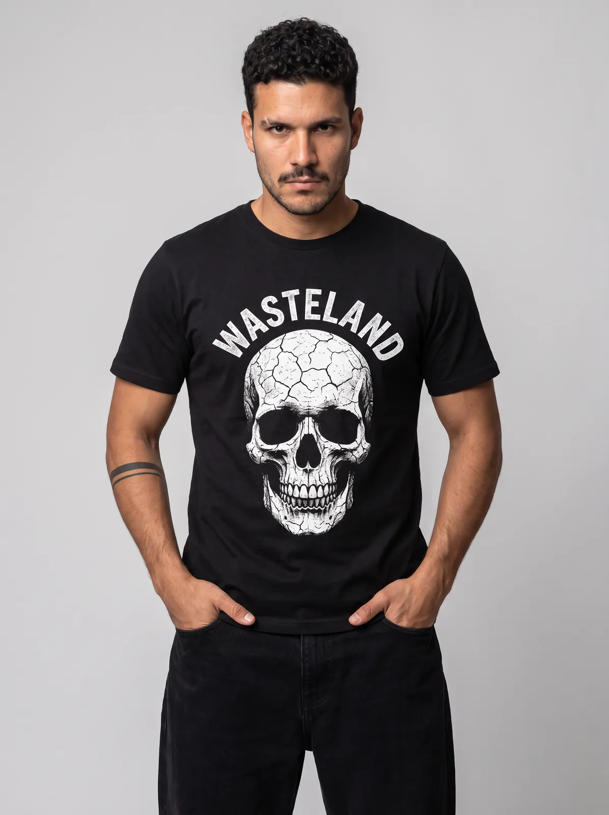 Diego Alvarez wearing the WASTELAND Tee in Black, waist up crop