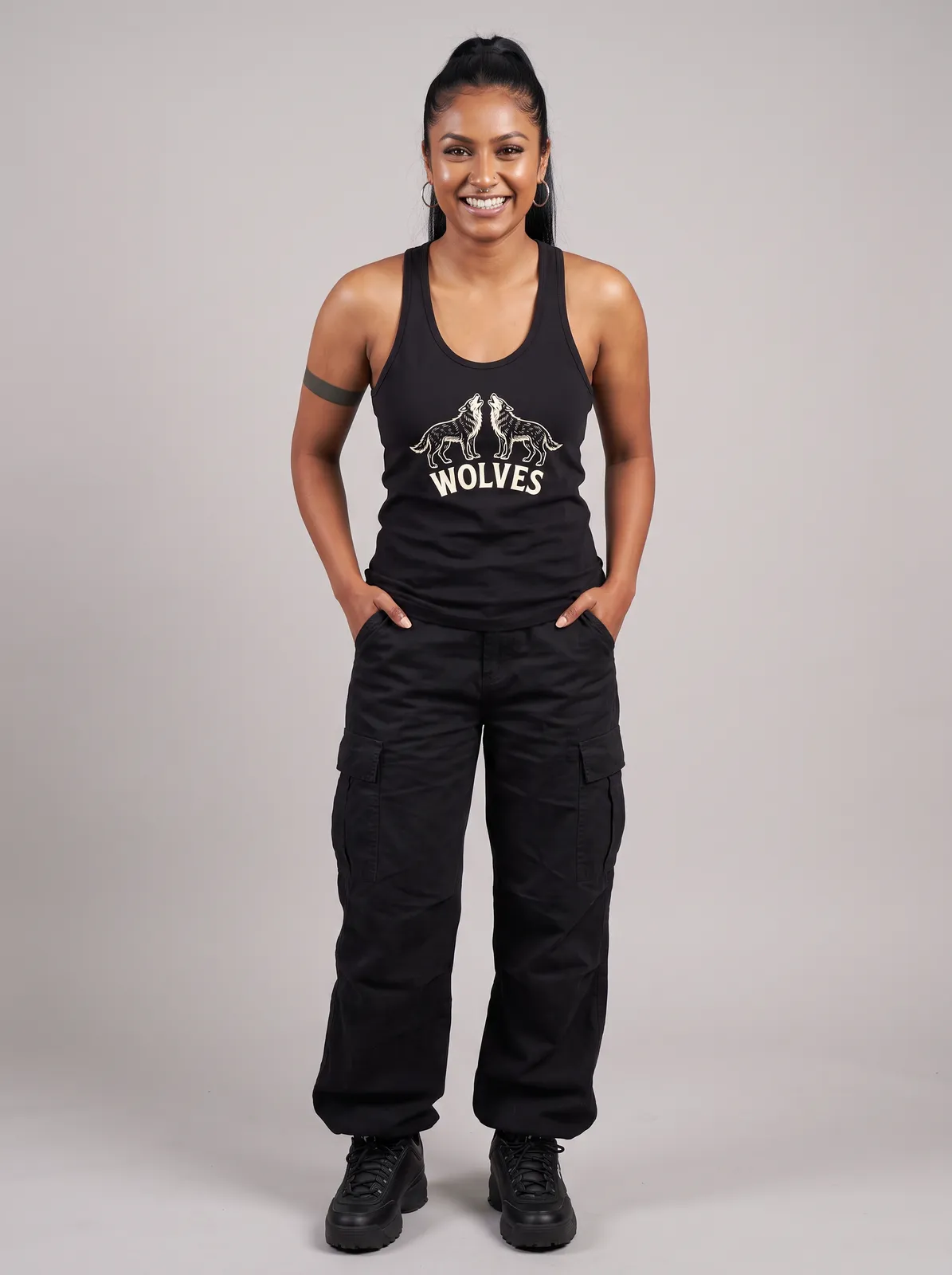Zara Mehta wearing the WOLVES Tank in Black, waist up crop